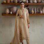 PAKISTANI BRUNETTE BEIGE DRESS.
